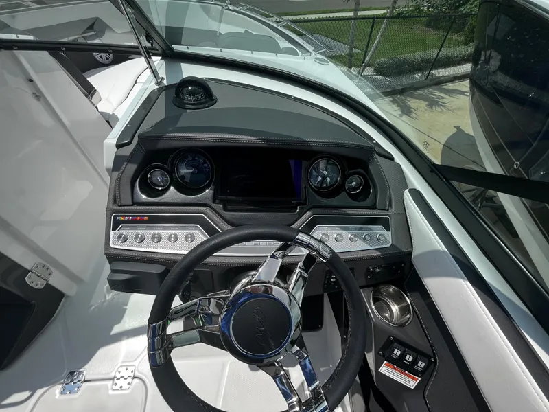 Slide: The Image of 2024 Monterey 275 Super Sport boat dashboard with modern controls and steering wheel. - 20