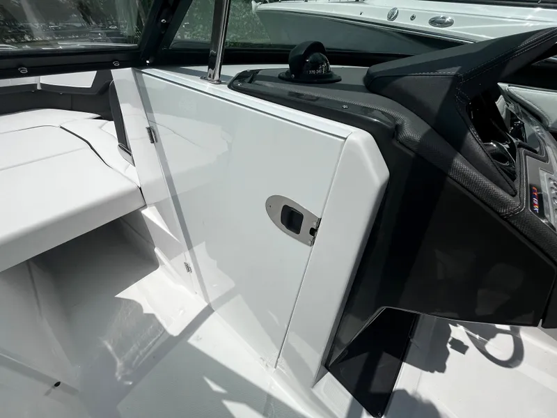 Slide: The Image of 2024 Monterey 275 Super Sport boat interior with sleek white and black design. - 21