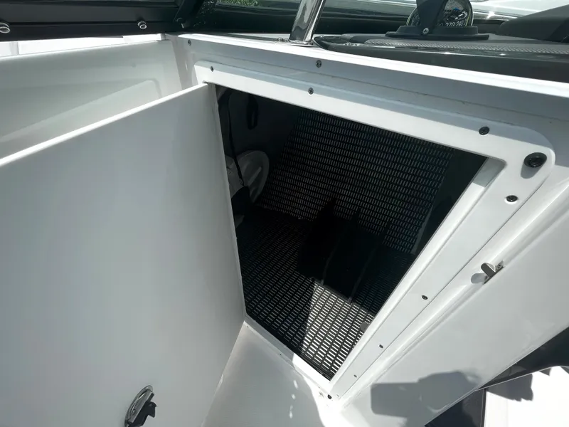 Slide: The Image of 2024 Monterey 275 Super Sport boat storage compartment with open door. - 22