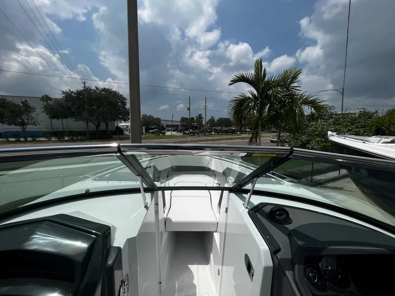 Slide: The Image of 2024 Monterey 275 Super Sport boat interior with open deck and clear skies. - 23