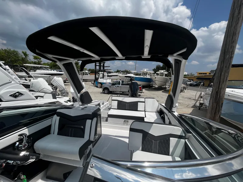 Slide: The Image of 2024 Monterey 275 Super Sport boat with sleek interior and black canopy. - 28