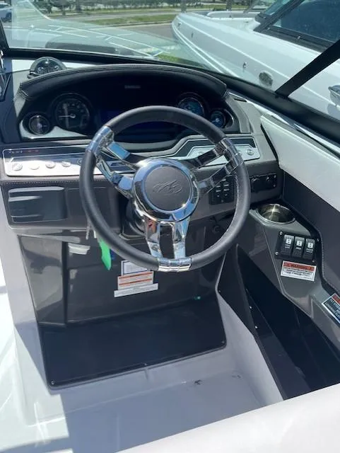 Slide: The Image of 2024 Monterey 275 Super Sport boat dashboard and steering wheel. - 35