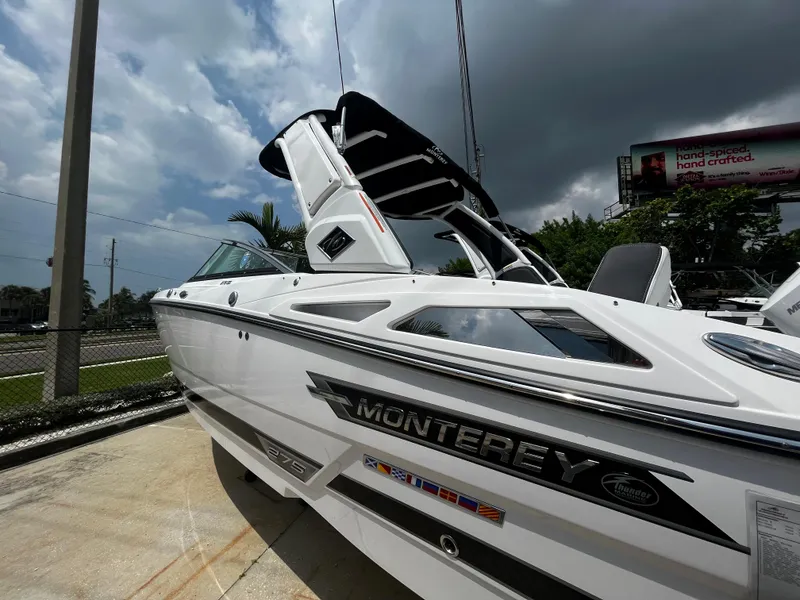 Slide: The Image of 2024 Monterey 275 Super Sport boat, white exterior, docked under cloudy sky. - 4