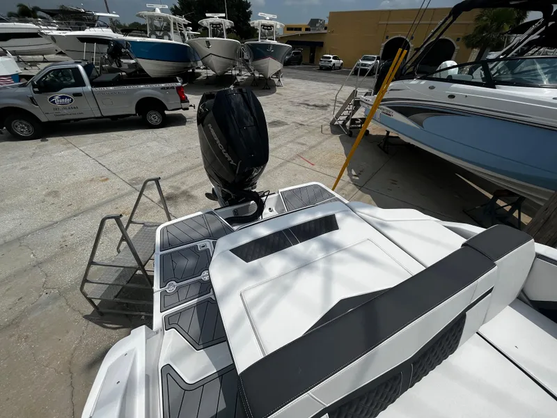 Slide: The Image of 2024 Monterey 275 Super Sport boat with outboard motor in a marina. - 8