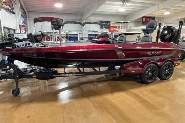 Slide: The Image of 2023 Vexus VX20 boat in showroom, red finish, on trailer, side view. - 10