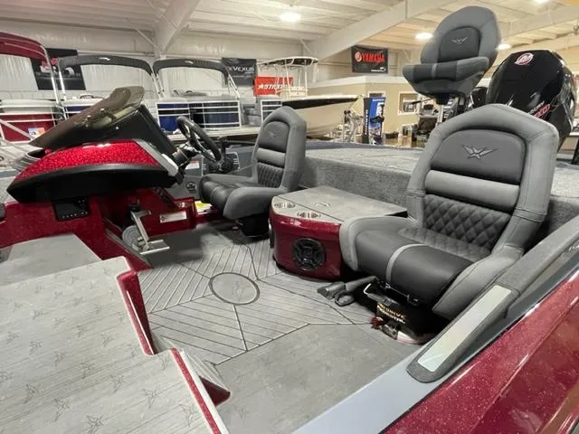 Slide: The Image of 2023 Vexus VX20 boat interior with gray seats and red accents in showroom. - 3