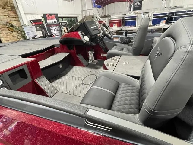 Slide: The Image of 2023 Vexus VX20 boat interior with black and gray seats, modern dashboard, and red accents. - 4