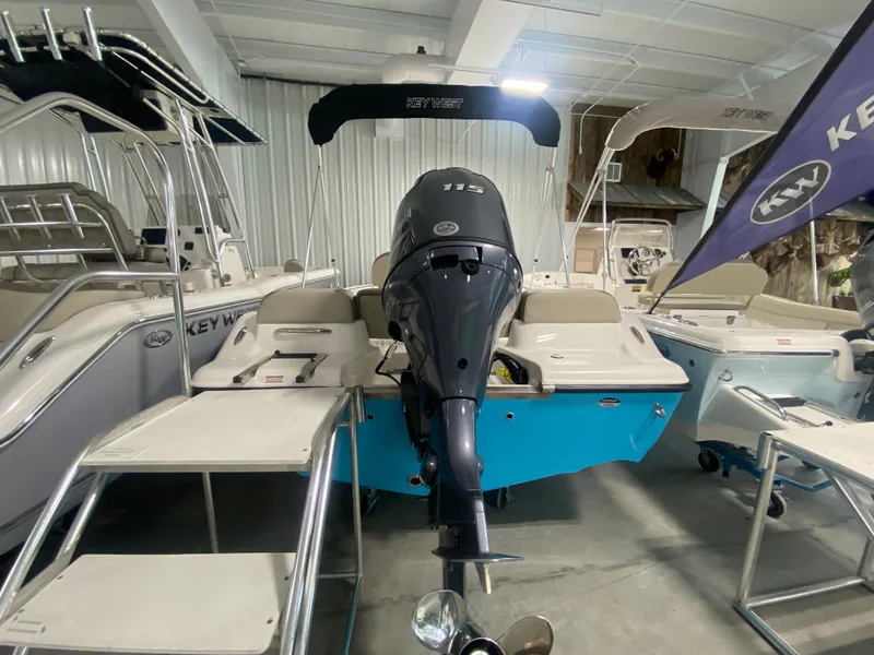 Slide: The Image of 2024 Key West 189 FS boat in showroom, rear view with outboard motor. - 5