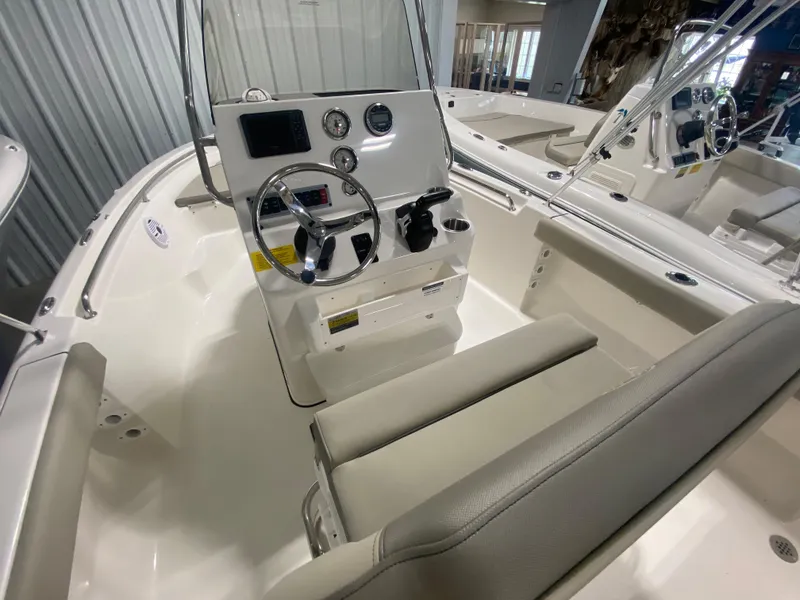 Slide: The Image of 2024 Key West 189 FS boat interior with steering console and seating. - 12
