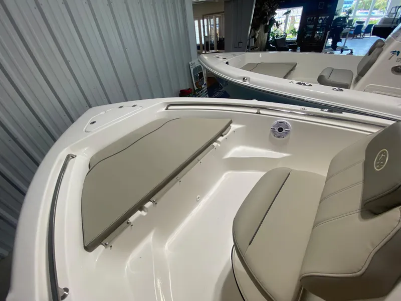 Slide: The Image of 2024 Key West 189 FS boat interior with cushioned seating and storage. - 18