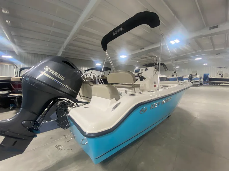 Slide: The Image of 2024 Key West 189 FS boat with Yamaha outboard motor in showroom. - 2