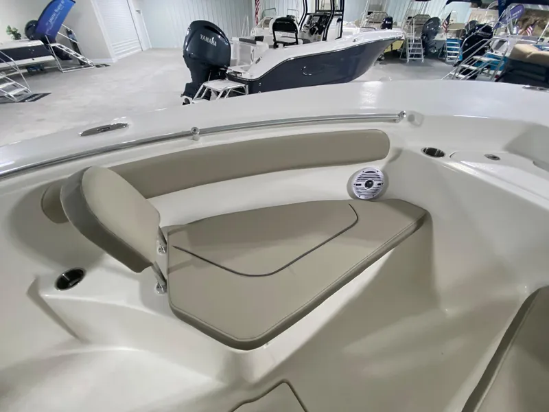 Slide: The Image of 2024 Key West 244 CC boat interior with cushioned seating and speaker. - 22