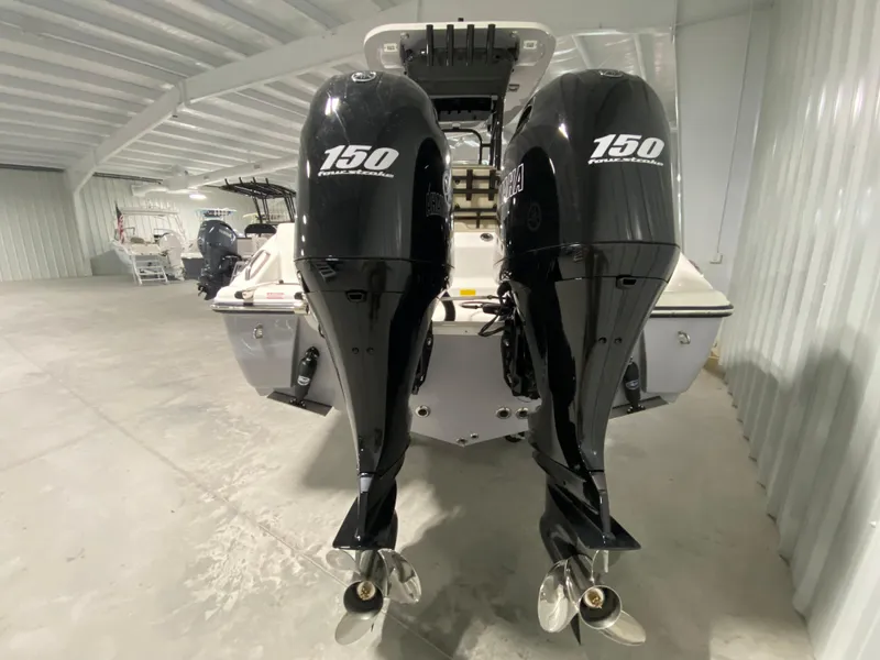 Slide: The Image of 2024 Key West 244 CC boat with twin 150 horsepower engines in a storage facility. - 4