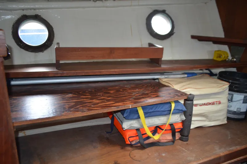 Slide: The Image of Interior of 1973 Skookum Ketch with life jackets and wooden shelves. - 27