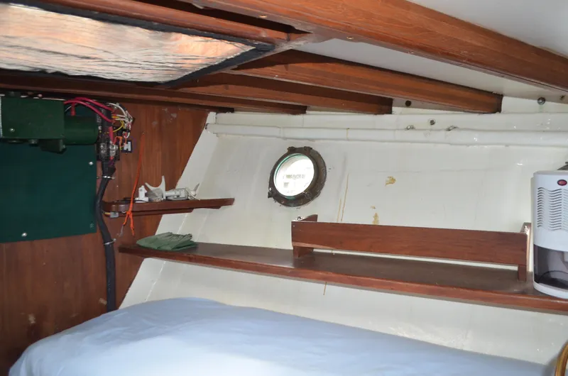 Slide: The Image of Interior of 1973 Skookum Ketch with wooden beams and porthole window. - 28