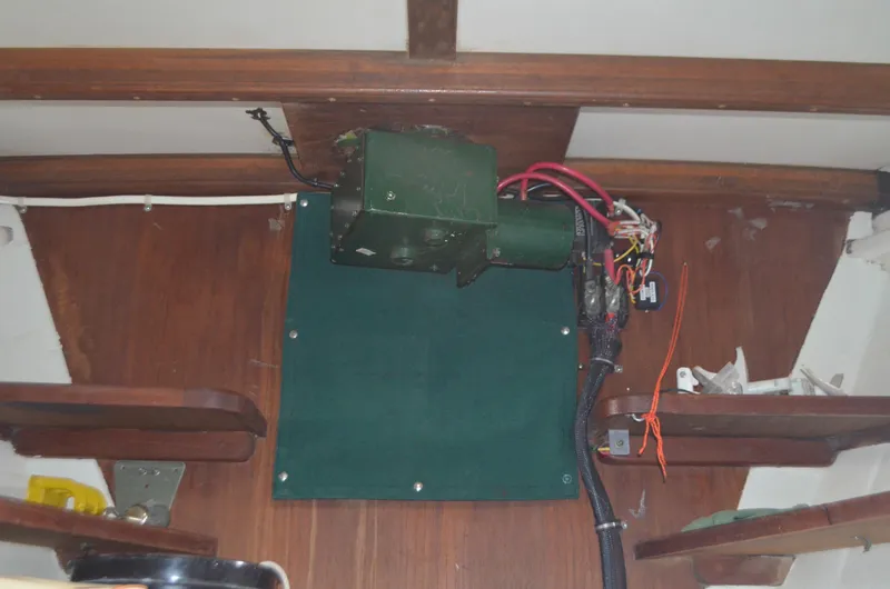 Slide: The Image of Interior view of a 1973 Skookum Ketch sailboat showing electrical wiring and wooden paneling. - 29