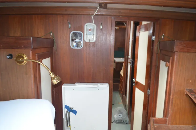 Slide: The Image of Interior of 1973 Skookum Ketch sailboat with wooden paneling and brass lamp. - 30