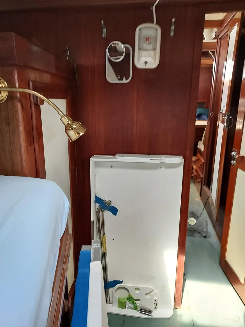 Slide: The Image of Interior of 1973 Skookum Ketch sailboat with wooden paneling and nautical decor. - 32