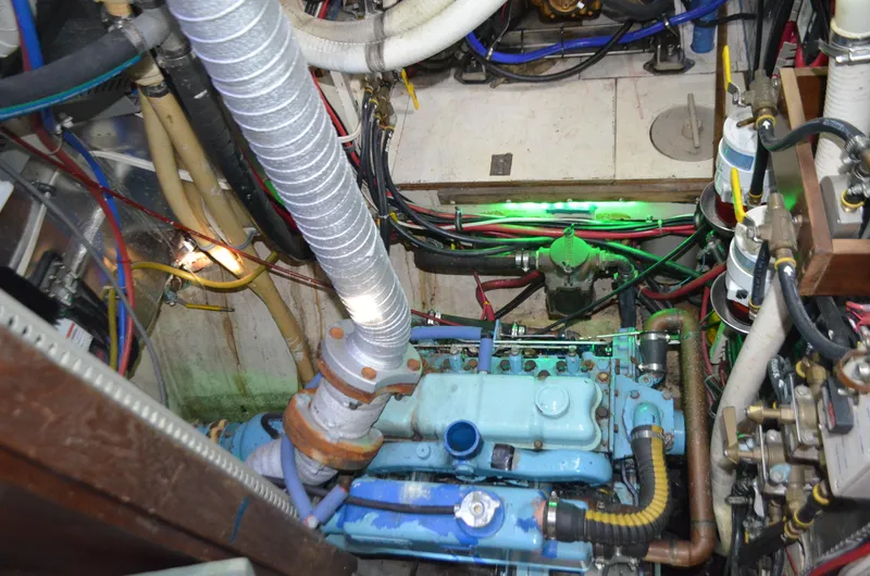 Slide: The Image of Engine room of a 1973 Skookum Ketch sailboat with visible wiring and components. - 35