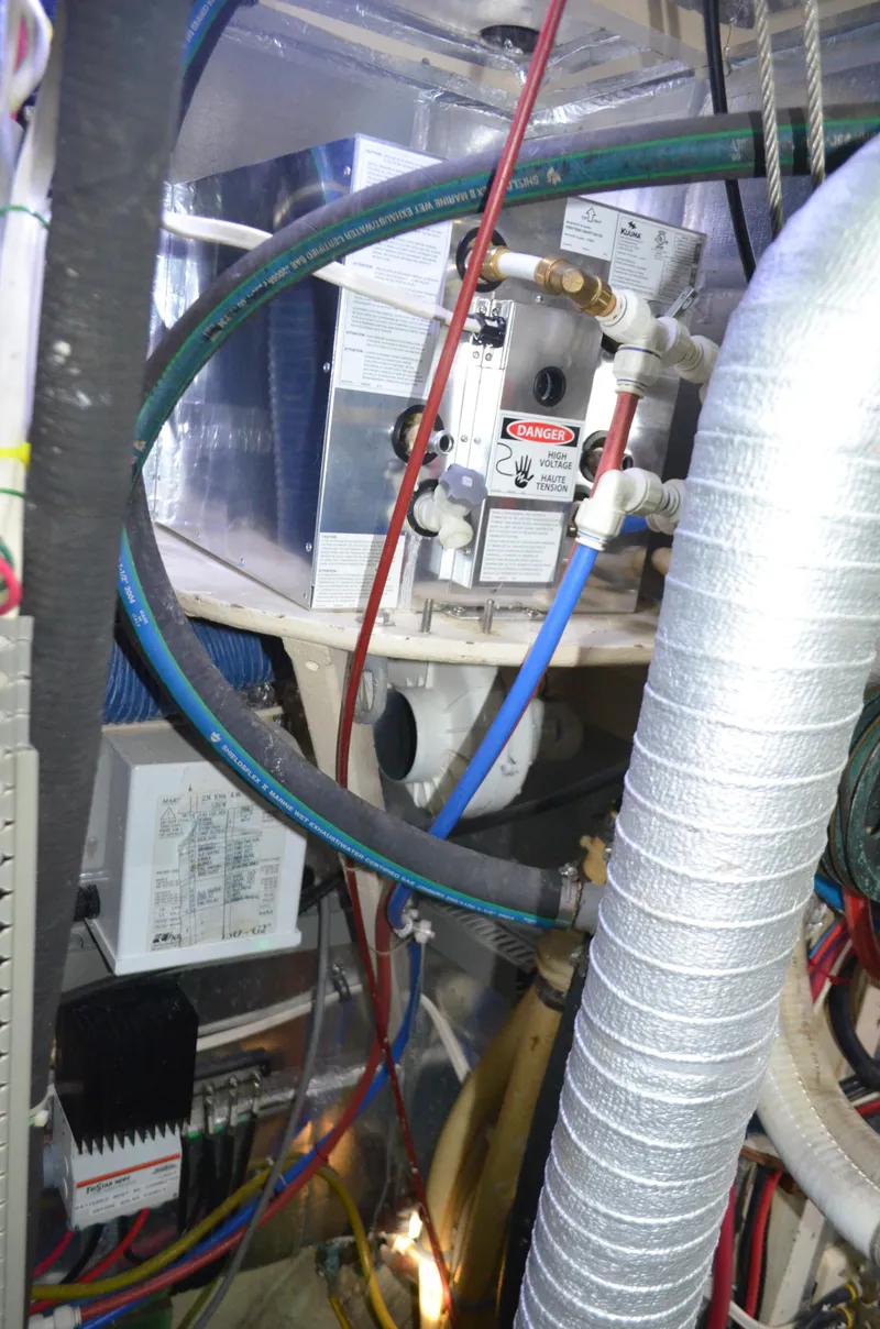 Slide: The Image of Engine room of a 1973 Skookum Ketch with various pipes and equipment. - 36