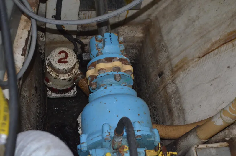 Slide: The Image of Engine room of 1973 Skookum Ketch with blue machinery and numbered valve. - 38