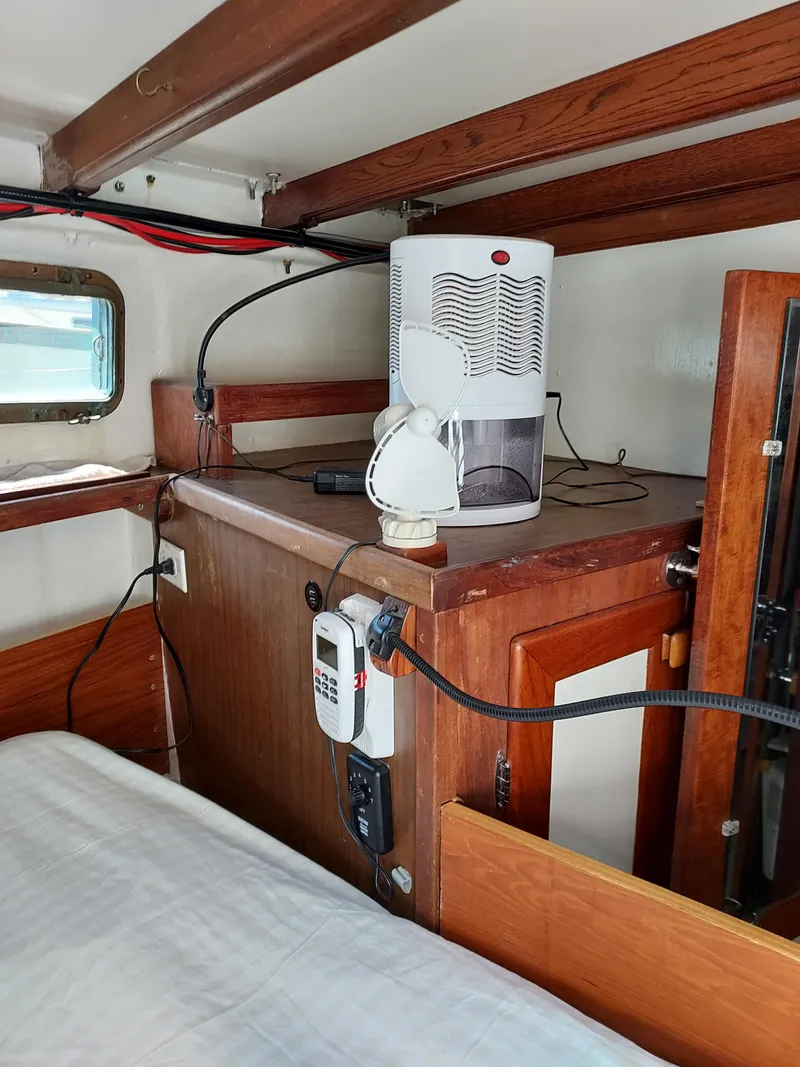 Slide: The Image of Interior of a 1973 Skookum Ketch boat with wooden cabinetry and modern appliances. - 42