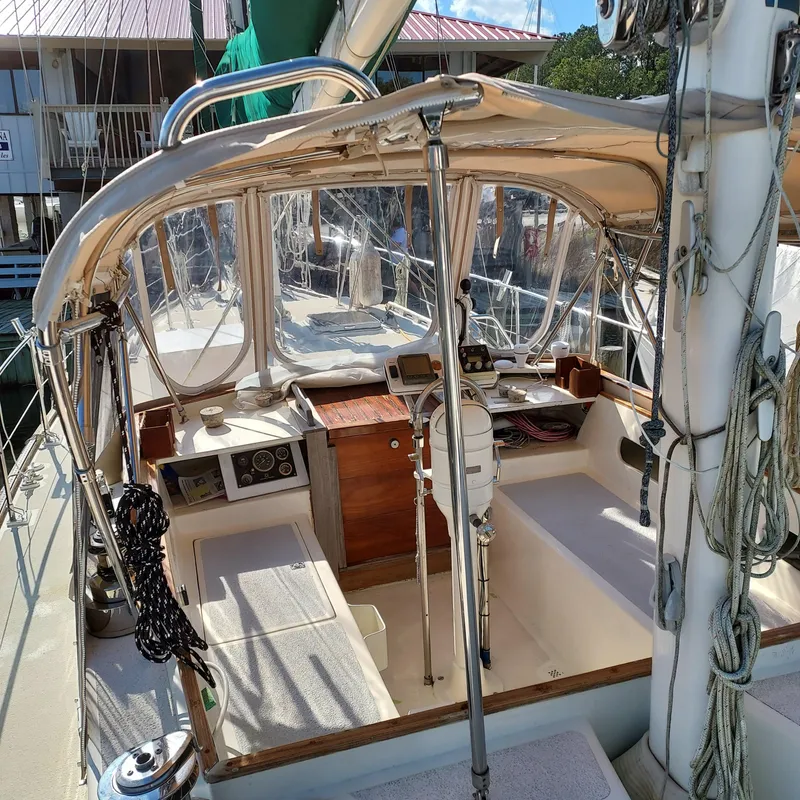 Slide: The Image of 1973 Skookum Ketch sailboat cockpit with navigation equipment and seating. - 6