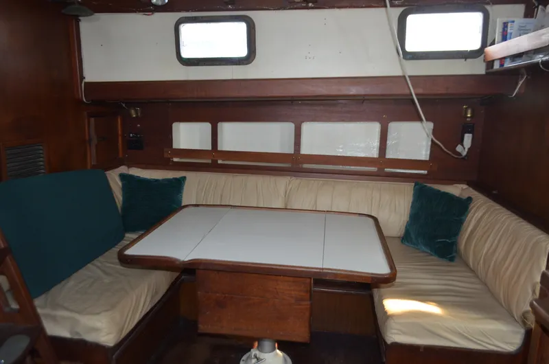 Slide: The Image of 1973 Skookum Ketch interior with cozy seating and wooden table. - 8