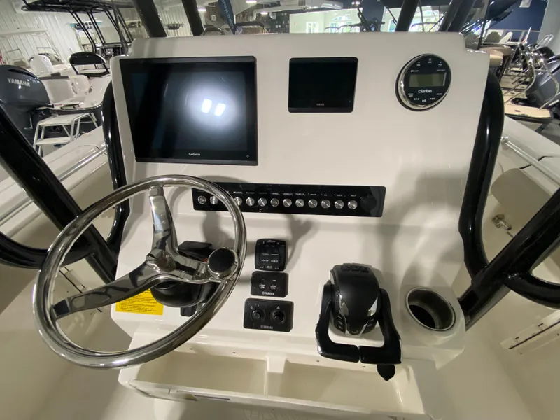 Slide: The Image of 2024 Key West 244 CC boat console with steering wheel, touchscreen, and controls. - 14