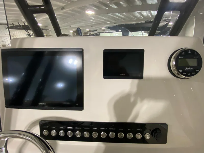 Slide: The Image of 2024 Key West 244 CC boat dashboard with electronic displays and control panel. - 15