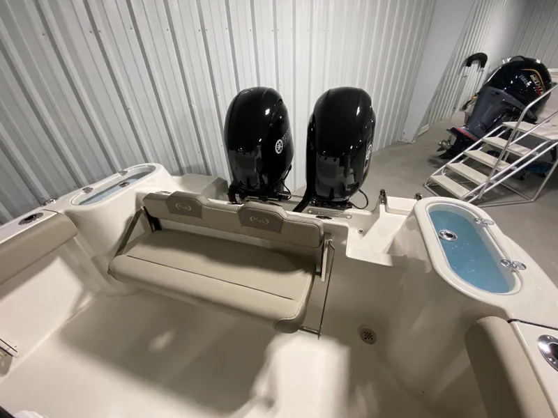 Slide: The Image of 2024 Key West 244 CC boat with twin outboard engines in a storage facility. - 8