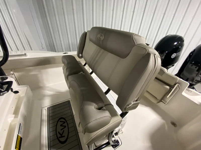 Slide: The Image of 2024 Key West 244 CC boat interior with cushioned seating and twin outboard motors. - 12