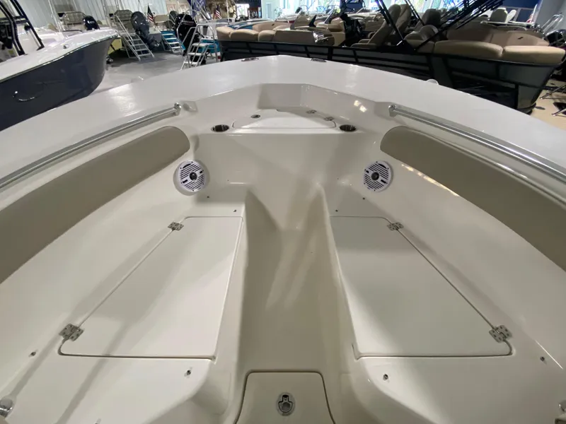 Slide: The Image of 2024 Key West 244 CC boat interior, spacious bow seating area with storage compartments. - 27