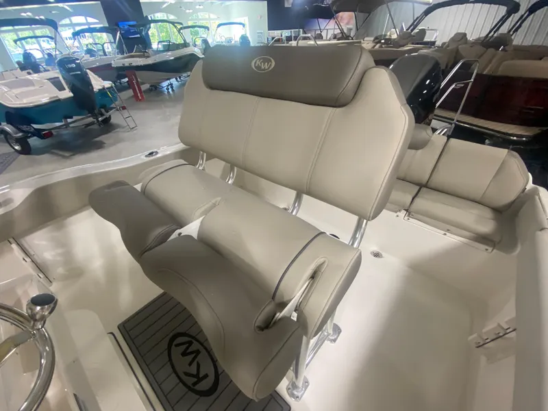 Slide: The Image of 2024 Key West 219 FS boat interior seating in showroom. - 10