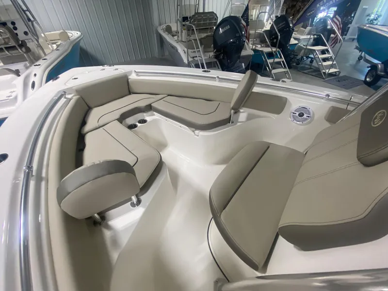 Slide: The Image of 2024 Key West 219 FS boat interior with cushioned seating and storage compartments. - 15