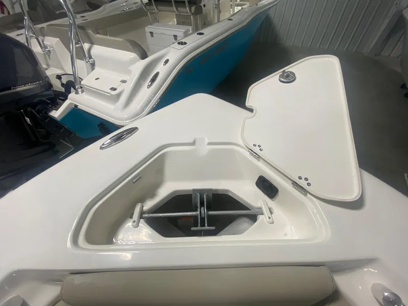 Slide: The Image of 2024 Key West 219 FS boat anchor storage compartment with open lid. - 22