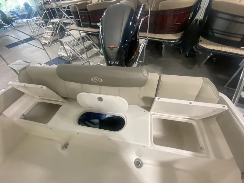 Slide: The Image of 2024 Key West 219 FS boat interior with storage compartments and 175 HP engine. - 7