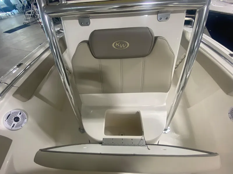 Slide: The Image of 2024 Key West 219 FS boat interior with cushioned seating and storage compartment. - 16