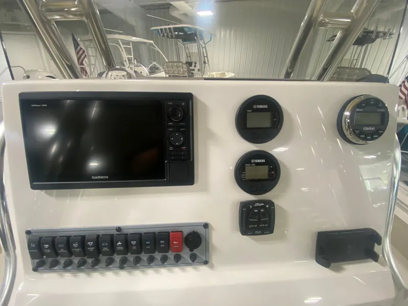Slide: The Image of 2024 Key West 219 FS boat dashboard with Garmin display and control panel. - 12