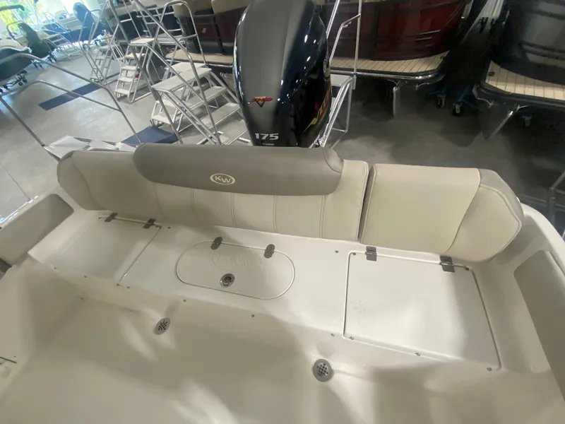 Slide: The Image of 2024 Key West 219 FS boat interior with cushioned seating and 175 HP outboard motor. - 6