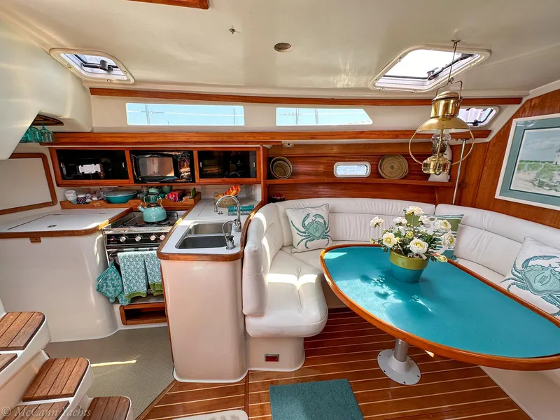 Slide: The Image of Interior of a 1991 Catalina 42 sailboat with cozy dining area and kitchen. - 16