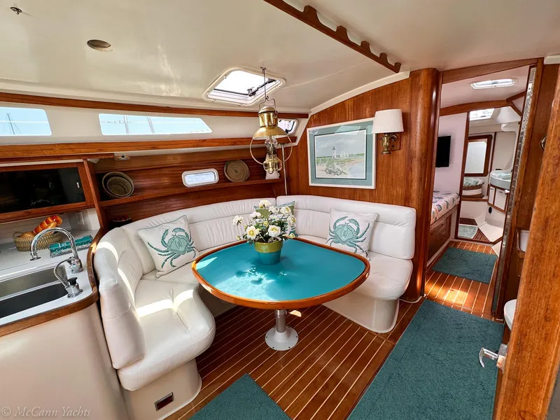 Slide: The Image of Interior of 1991 Catalina 42 yacht with cozy dining area and elegant wood finishes. - 17