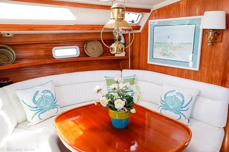 Slide: The Image of Interior of a 1991 Catalina 42 yacht with elegant wood finish and cozy seating area. - 18