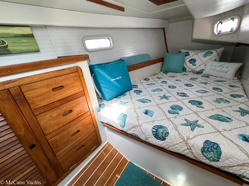 Slide: The Image of Cozy cabin interior of 1991 Catalina 42 sailboat with nautical-themed bedding. - 20