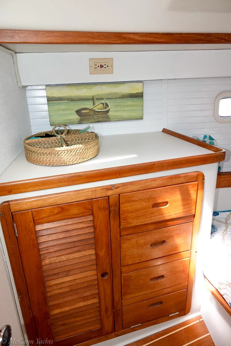 Slide: The Image of Interior of 1991 Catalina 42 sailboat with wooden cabinets and nautical decor. - 21