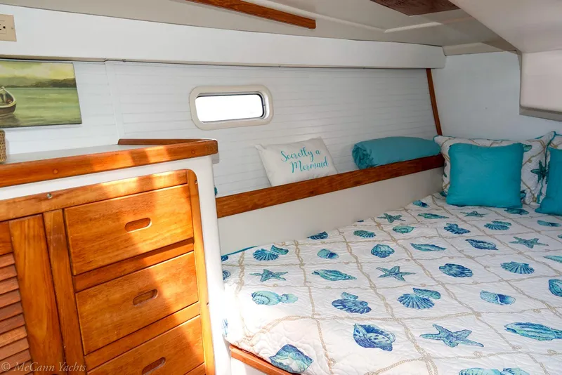 Slide: The Image of Cozy cabin interior of 1991 Catalina 42 sailboat with nautical-themed bedding. - 22