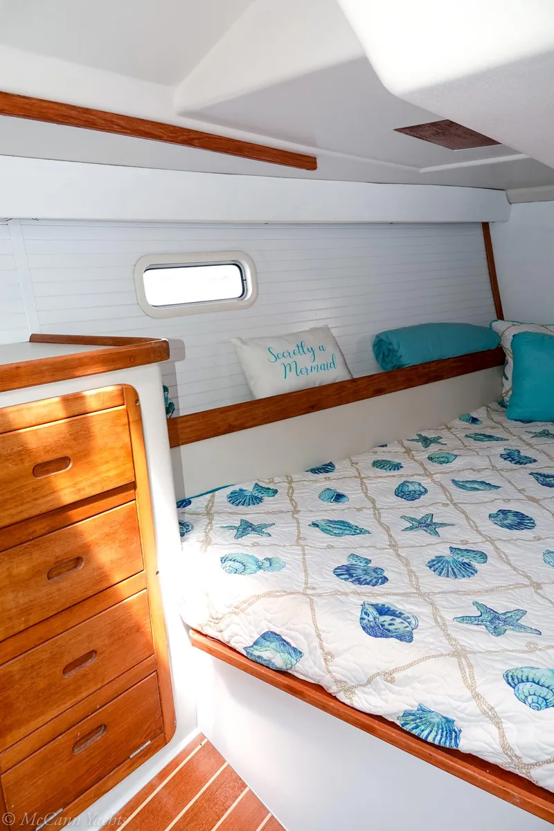 Slide: The Image of Cozy cabin interior of 1991 Catalina 42 sailboat with nautical-themed bedding. - 23