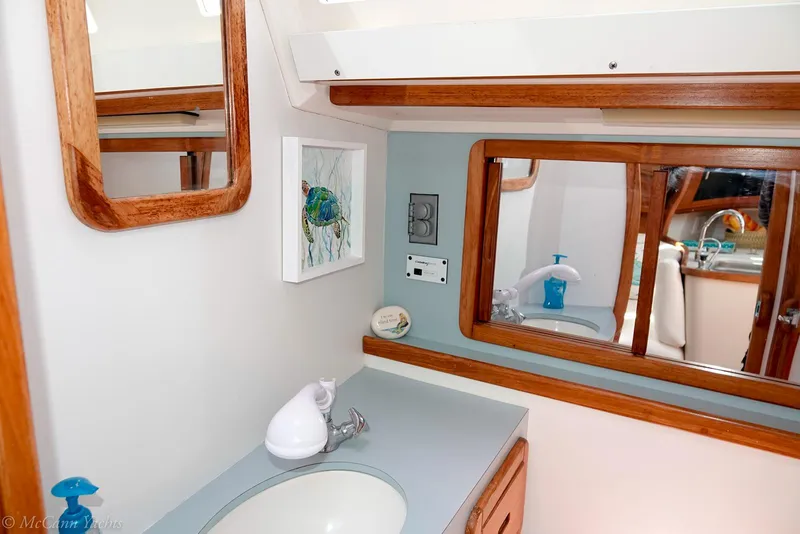 Slide: The Image of Bathroom interior of a 1991 Catalina 42 yacht with wooden accents and modern fixtures. - 25