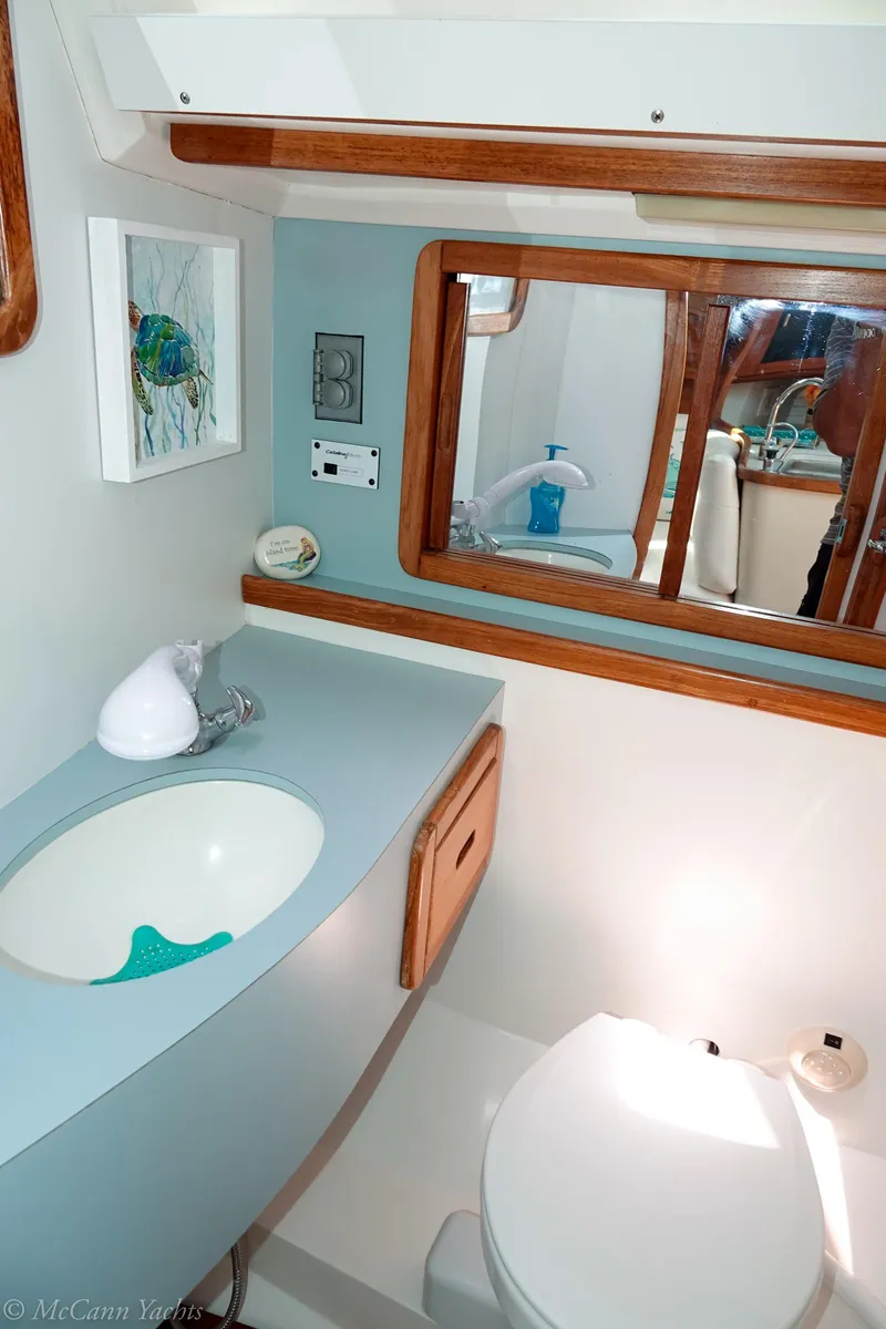 Slide: The Image of 1991 Catalina 42 yacht bathroom with sink, mirror, and toilet. - 26