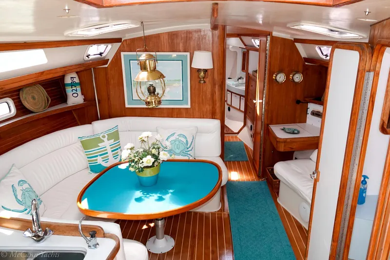 Slide: The Image of Interior of a 1991 Catalina 42 sailboat with elegant wood finish and cozy seating area. - 28